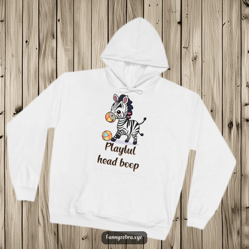 Soft hoodie featuring a funny zebra silhouette engaging in playful ball-bouncing with its nose, perfect for cozy fun.